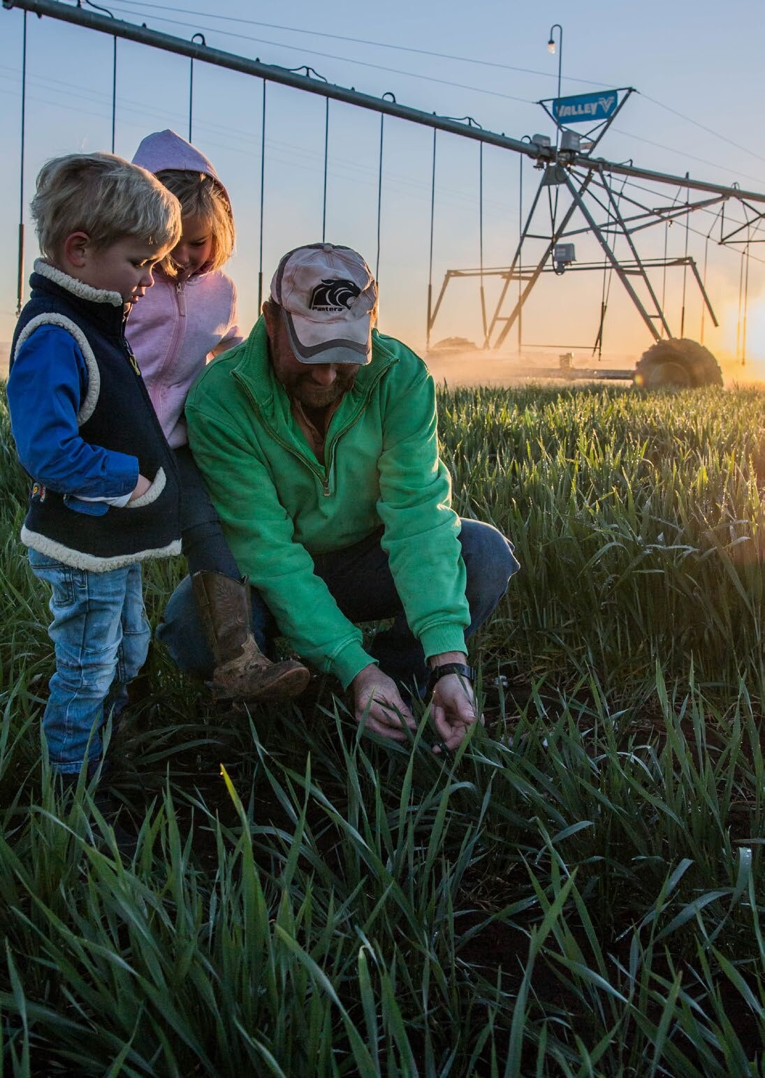 A Victorian farmer in a paddock with two young children